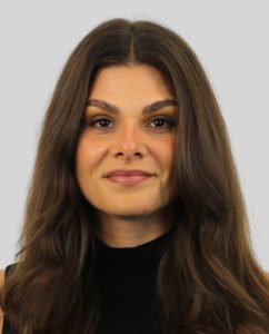 Professional portrait of a woman with long brown hair, smiling softly, representing Wellspring Counselling's compassionate team.