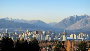 Vancouver skyline and snow-covered North Shore Mountains viewed from Queen Elizabeth Park.