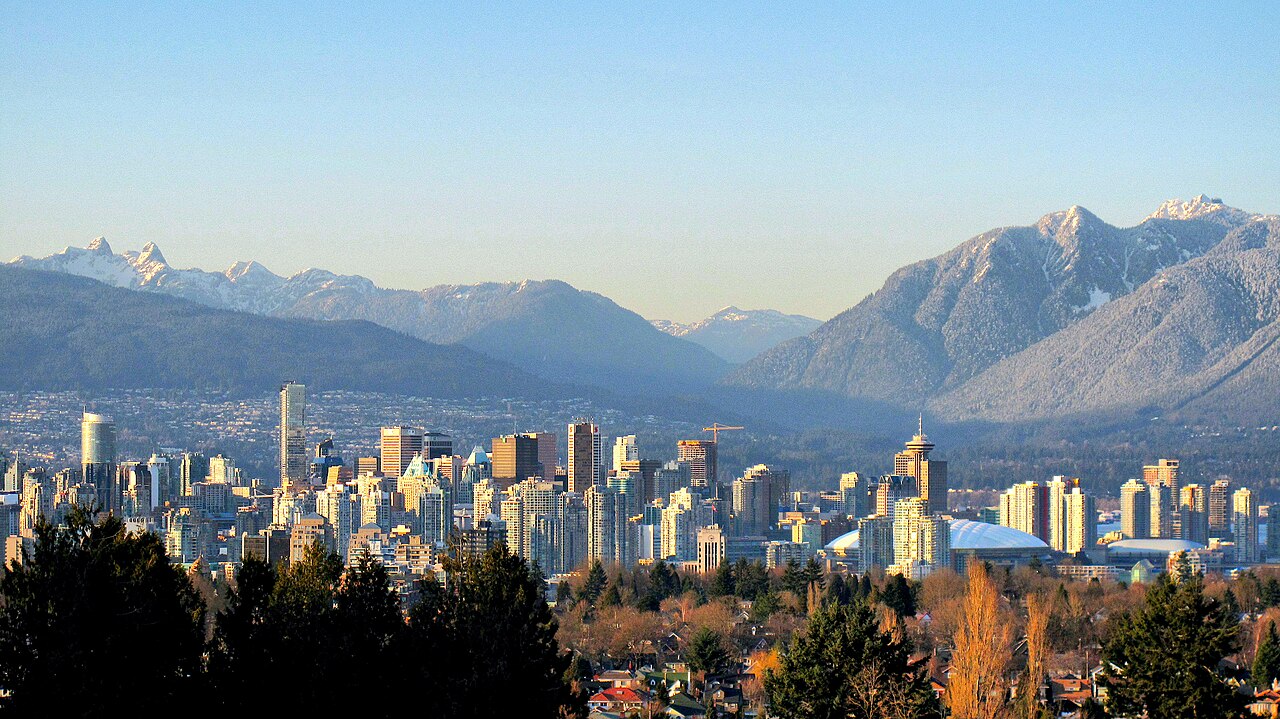 Vancouver skyline and snow-covered North Shore Mountains viewed from Queen Elizabeth Park.