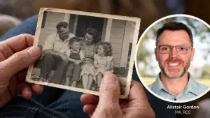 Hands holding an old family photograph, with an inset portrait labelled Alistair Gordon, MA, RCC.